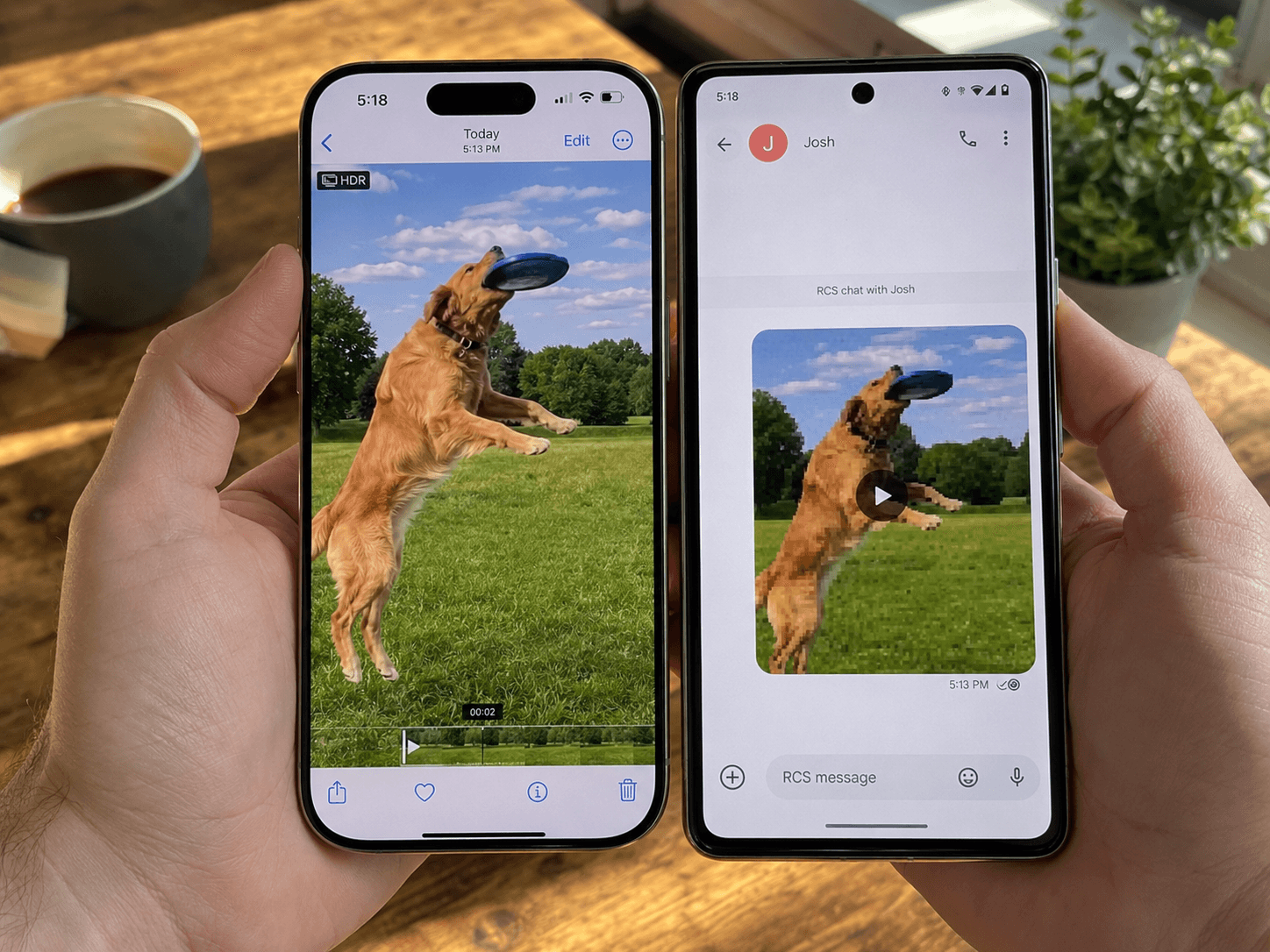 An iPhone and a Pixel-style Android phone held side by side at a desk, both paused on the same video frame. The iPhone shows the original crisp footage; the Android shows the same frame received via text, visibly blocky and washed out.